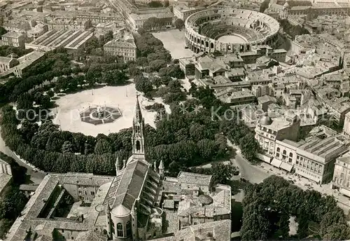 AK / Ansichtskarte Nimes Vue aerienne Eglise Sainte Perpetue la fontaine Pradier et les Arenes Nimes