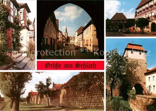 AK / Ansichtskarte Sesslach Dorfastrasse Fachwerkhaeuser Stadtmauer Stadtturm Sesslach