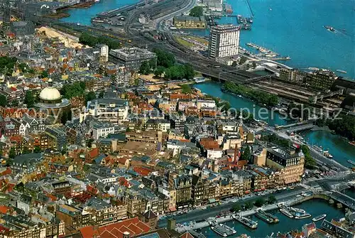 AK / Ansichtskarte Amsterdam_Niederlande Damrak Lutherische Kirche Hafengebaeude Fliegeraufnahme Amsterdam_Niederlande