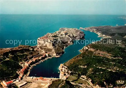 AK / Ansichtskarte Bonifacio_Corse_du_Sud Vue aerienne du port et de la ville sur les falaises entourees par le goulet et la mer Bonifacio_Corse_du_Sud