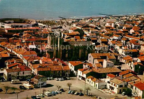 AK / Ansichtskarte Les_Saintes Maries de la Mer Vue aerienne de leglise fortifiee les arenes et la plage Les