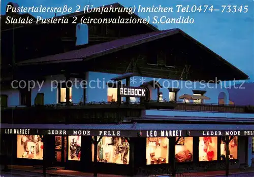 AK / Ansichtskarte Innichen_Suedtirol Leo Market Lederwarengeschaeft Nachtaufnahme Innichen Suedtirol