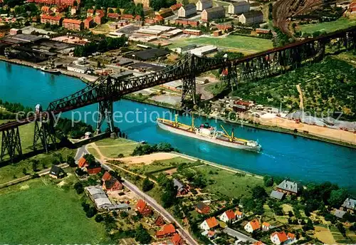 AK / Ansichtskarte Rendsburg Hochbruecke ueber den Nord Ostsee Kanal mit Schwebefaehre Fliegeraufnahme Rendsburg