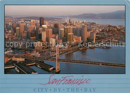 AK / Ansichtskarte San_Francisco_California Morning sun lights Oakland Bay Bridge and city skyline aerial view 