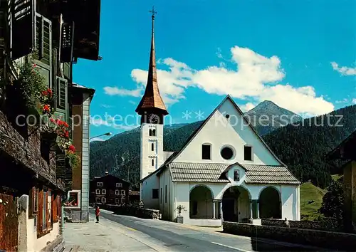 AK / Ansichtskarte Muenster_Goms_VS Dorfstrasse mit Kirche 