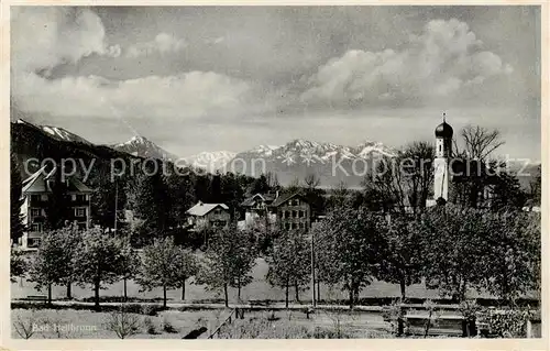 AK / Ansichtskarte  Bad_Heilbrunn Ortsansicht mit Kirche Alpenblick Bad_Heilbrunn