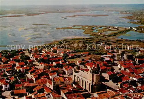 AK / Ansichtskarte  Les_Saintes-Maries-de-la-Mer Vue aerienne de lEglise fortifiee La Camargue et la route des Marais Les
