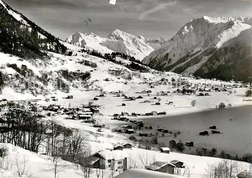 AK / Ansichtskarte  Klosters_GR Panorama Wintersportplatz mit Klosters-Dorf gegen Silvrettagruppe Klosters_GR
