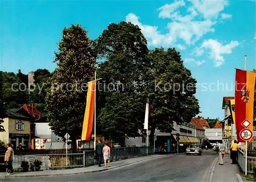 AK / Ansichtskarte 73865922 Bad_Soden-Salmuenster Salz-Bruecke mit Kaufhaus und Burgruine Fahnen Bad_Soden-Salmuenster