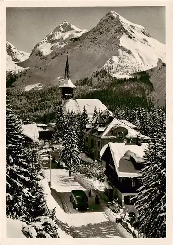 AK / Ansichtskarte  Arosa_GR Dorfkirche Blick auf Furkahoerner Winter in den Alpen Arosa_GR