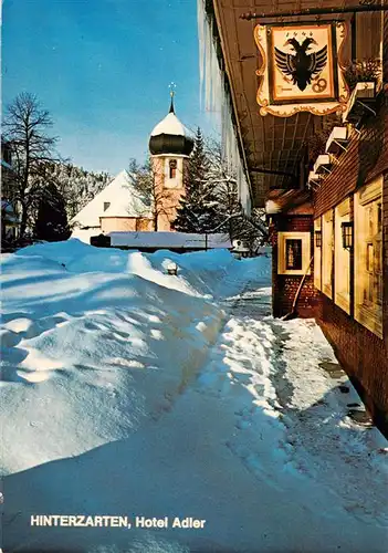 AK / Ansichtskarte 73904866 Hinterzarten Hotel Adler mit Kirche Maria in der Zarten im Winter