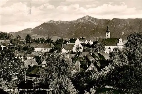 AK / Ansichtskarte 73910199 Murnau_Staffelsee Stadtpanorama mit Blick gegen Herzogstand und Heimgarten