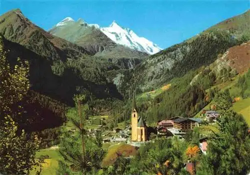 AK / Ansichtskarte 73970535 HEILIGENBLUT_Kaernten_AT Ortsansicht mit Kirche Blick gegen Grossglockner Hohe Tauern