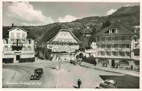 AK / Ansichtskarte KuessNACHT Vierwaldstaettersee SZ Dorfplatz mit Rigi Hotel Adler Gasthof Sonne