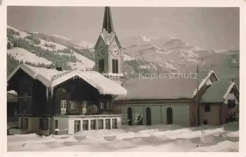 AK / Ansichtskarte Lenk Simmental BE Teilansicht mit Kirche im Winter Berner Alpen