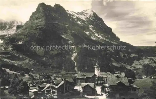 AK / Ansichtskarte Grindelwald BE Ortsansicht mit Kirche Blick gegen Hoernli und Eiger Berner Alpen