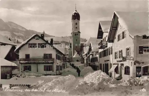 AK / Ansichtskarte Nesselwang Allgaeu Bayern Dorfstrasse mit Alpspitze tiefverschneite Strassen