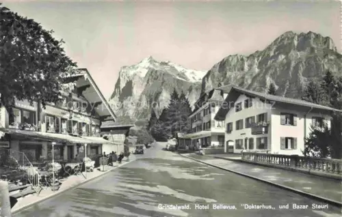 AK / Ansichtskarte Grindelwald BE Hotel Bellevue Dokterhus und Bazar Steuri Blick gegen Wetterhorn und Mettenberg