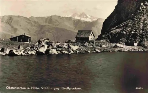 AK / Ansichtskarte Obstanser See Obstansersee Kartitsch Osttirol AT Berghuetten am See Blick gegen Grossglockner