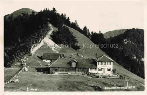 AK / Ansichtskarte Kreuzegg Restaurant 1317m Wattwil Toggenburg SG Wirtschaft-Kreuzegg Gasthaus Kuehe Berghang Weide Alp Toggenburg