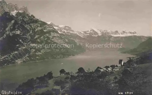 AK / Ansichtskarte Obstalden Glarus GL Walensee See Bergpanorama Dorf Kirche Schneeberge Wiesen