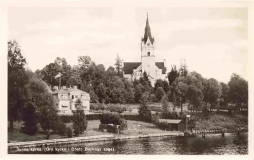 AK / Ansichtskarte Sunne Varmlands Lan Sweden Sunne-kyrka Bro-kyrka Goesta-Berlings-saga Kirche Seeufer Fryken