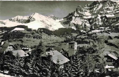 AK / Ansichtskarte Adelboden Frutigen BE Kirche Bunderspitz Nuenihorn Alpen Schnee Dorf Tannen