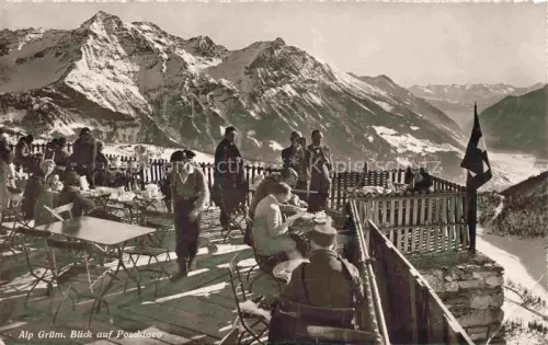AK / Ansichtskarte Alp Gruem Bernina GR Alp-Gruem Bergrestaurant Terrasse Bergpanorama Alpen Schnee Poschiavo-Tal Wanderer Schweizer-Flagge