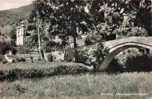 AK / Ansichtskarte Sarnen Obwalden OW Schwyhbogen Bruecke Kirche Baeume Wiese Fluss Kirchturm