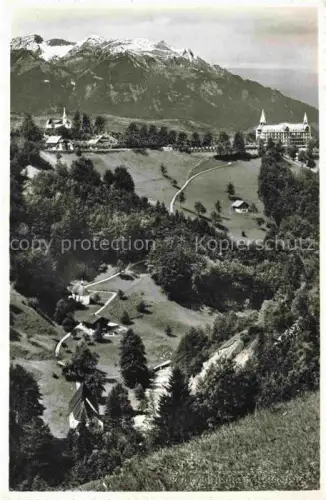 AK / Ansichtskarte Flueeli-Ranft Fluehli-Ranft OW Hotel Kapelle Bergpanorama Wiese Baeume Alpen Gebaeude