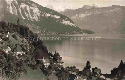 AK / Ansichtskarte Gunten Thunersee BE Thunersee Eiger Moench Jungfrau Seeufer Haeuser Wald Berge