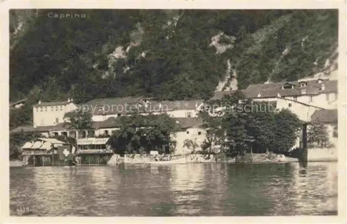 AK / Ansichtskarte Caprino Lugano TI Restaurant-Caprino Seeufer Ortschaft Felsen Boot S/W-Fotografie