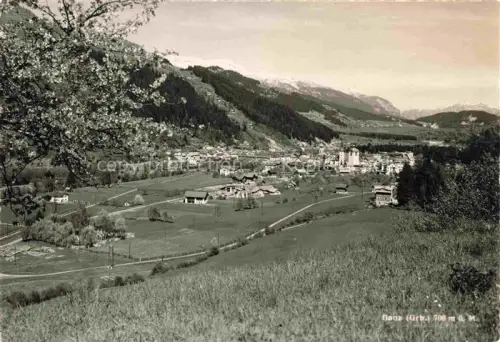AK / Ansichtskarte Ilanz Jlanz Glion GR Dorf Kirche Berge Tal Felder Baeume Fruehlingslandschaft