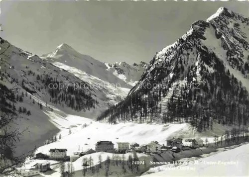 AK / Ansichtskarte Samnaun Dorf GR Samnaun Muttler Winterlandschaft Unterengadin Schnee Berglandschaft Dorfansicht Tannen