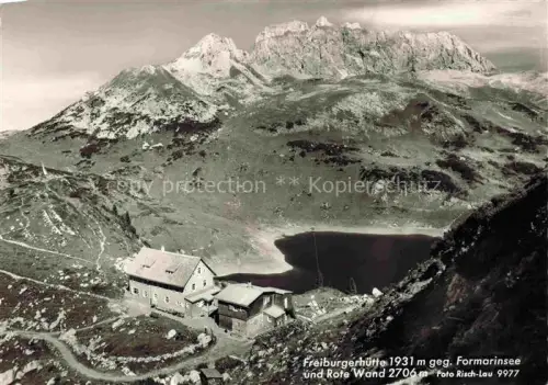 AK / Ansichtskarte Freiburgerhuette 1934m Vorarlberg AT Freiburgerhuette Formarinsee Rote-Wand Bergsee Berglandschaft Fels Almgebaeude S/W-Fotokarte
