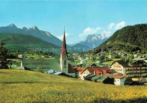 AK / Ansichtskarte SEEFELD Tirol AT Kirche Dorf Wetterstein Karwendel Bergpanorama Wiese Haeuser Talblick