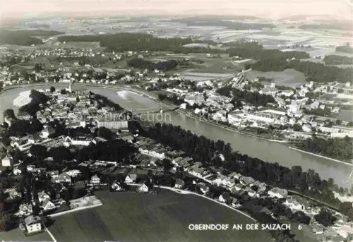 AK / Ansichtskarte Oberndorf Salzburg AT Luftbild Salzach Bruecke Ortschaft Felder Fluss Wohnhaeuser Kirche