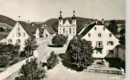 AK / Ansichtskarte Arlesheim BL Dom Stiftskirche Domplatz Brunnen Baeume Wohnhaeuser Huegel