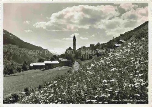 AK / Ansichtskarte Somvix Rabius Surselva GR Kirche Bergtal Dorf Blumenwiese Berge Kirchturm Buendner-Oberland