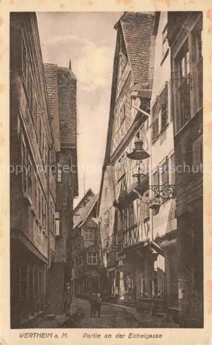 AK / Ansichtskarte Wertheim Main BW Eichelgasse Fachwerkhaus Gasse Laterne Passanten Altstadt