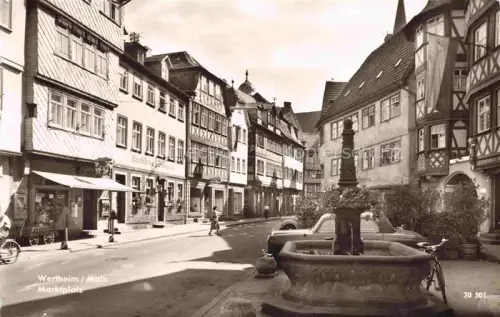 AK / Ansichtskarte Wertheim Main BW Marktplatz Brunnen Fachwerkhaus Geschaefte Passanten VW-Kaefer Brunnen