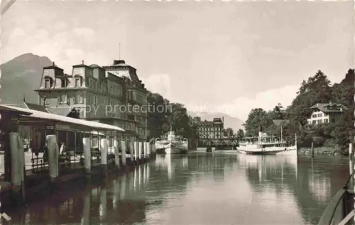 AK / Ansichtskarte INTERLAKEN BE Ost-Schiffstation Dampfschiff Schiffsanleger Hotel Fluss Berge Baeume