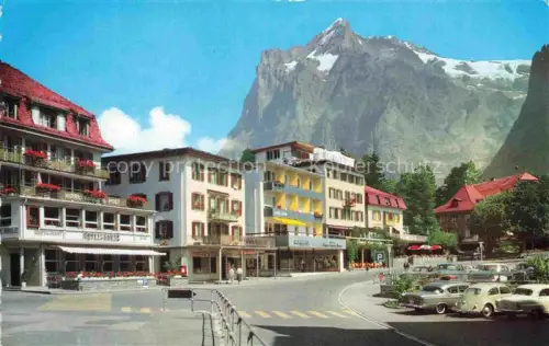 AK / Ansichtskarte Grindelwald BE Wetterhorn Dorfplatz Hotel-Zur-Post Geschaefte Autos Bergpanorama Gletscher