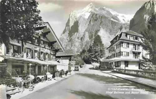 AK / Ansichtskarte Grindelwald BE Wetterhorn Hotel-Bellevue Bazar-Steuri Strasse Berge Dorf Autos