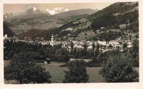 AK / Ansichtskarte Ilanz Jlanz Glion GR Toedikette Stadtpanorama Kirche Berge Alpen Waelder Wiesen