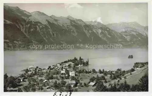 AK / Ansichtskarte Iseltwald Brienzersee Interlaken BE Brienzersee Dorf Kirche See Bergpanorama Halbinsel Wald