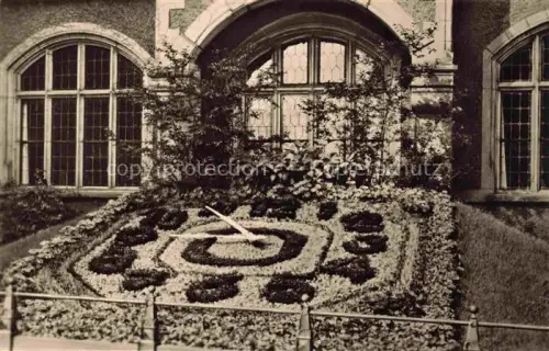 AK / Ansichtskarte Bernburg Saale Blumenuhr Bogenfenster Gebaeude Park Blumen Historismus