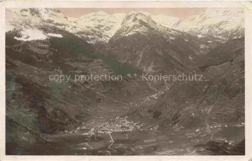 AK / Ansichtskarte Poschiavo GR Fliegeraufnahme Alpental Bergdorf Schneeberge Waelder Wiesen Talboden