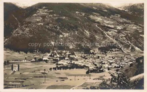 AK / Ansichtskarte Poschiavo GR Talboden Bergpanorama Felder Kirchturm Waelder Ortschaft Fliegeraufnahme