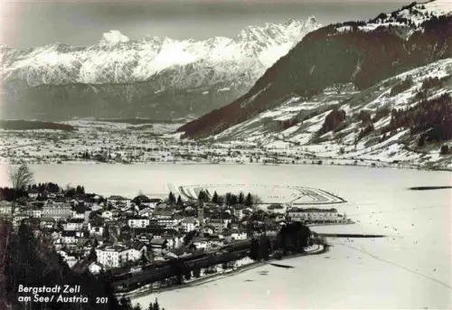 AK / Ansichtskarte Zell See AT Zeller-See See Winter Schnee Bergpanorama Alpen Ortschaft Kirche Luftaufnahme